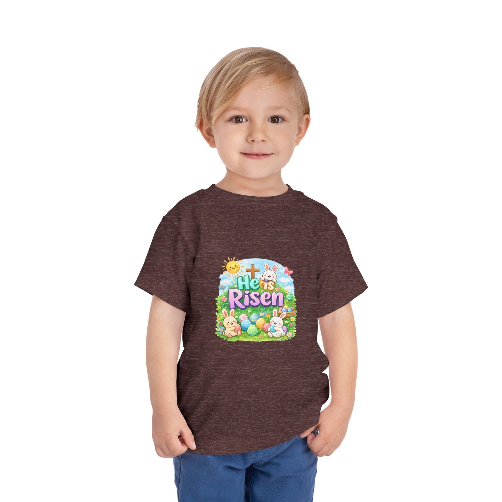 He Is Risen toddler tee with Easter bunny, cross, and pastel eggs design on soft lightweight fabric