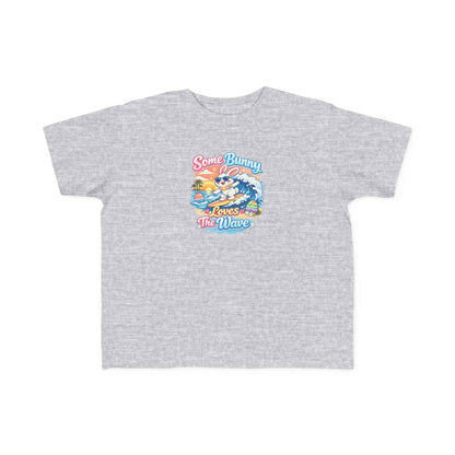 Some Bunny Loves The Wave Easter T-shirt with a surfing bunny and pastel eggs on sunset wave background