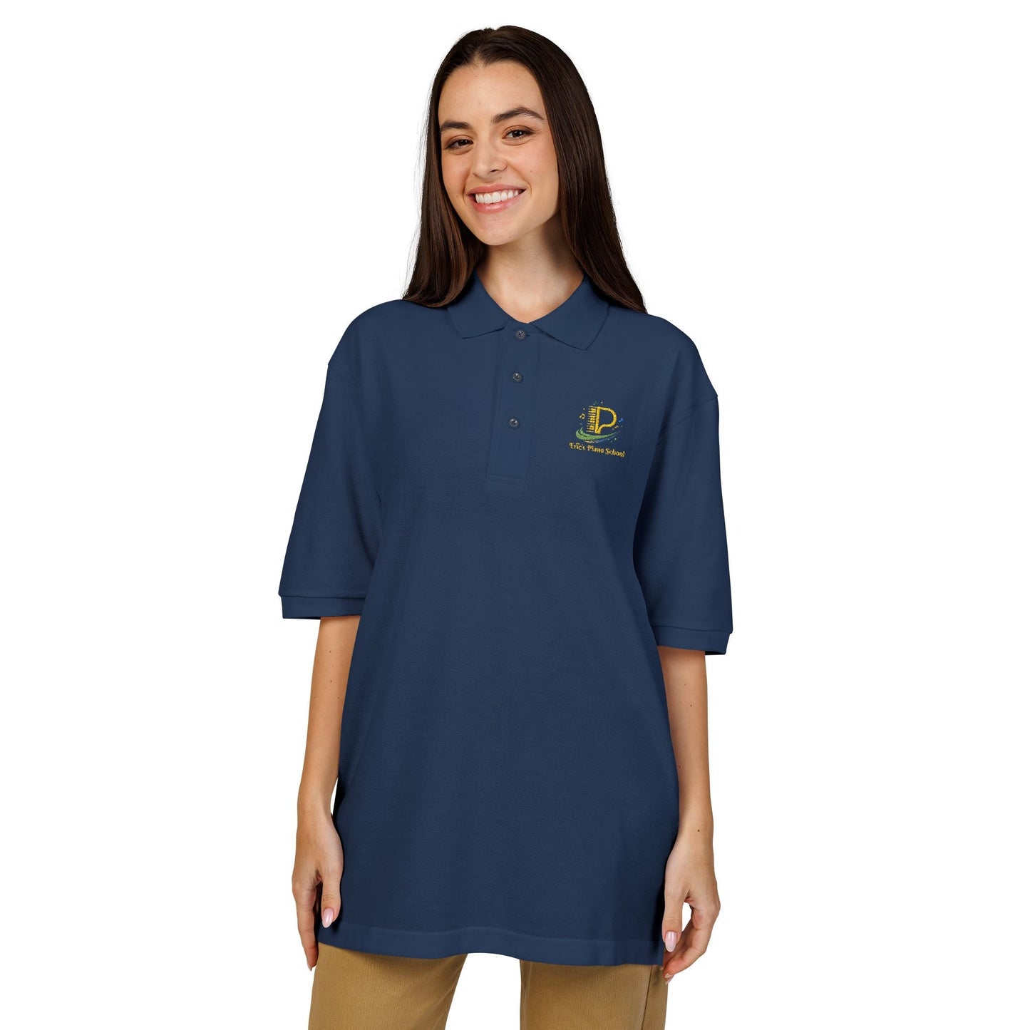 Embroidered crest polo shirt with relaxed fit, lightweight pique fabric, flat knit collar, metal buttons, and subtle chest logo detail