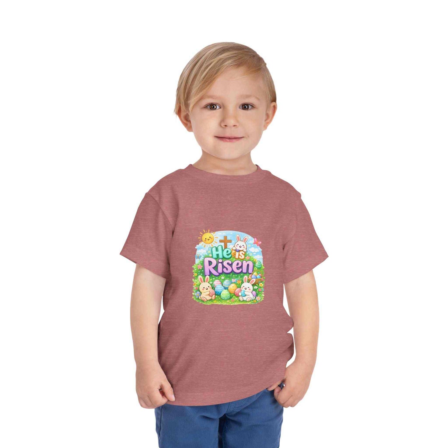 Toddler wearing He Is Risen Tee with Easter bunny and cross design on pastel shirt