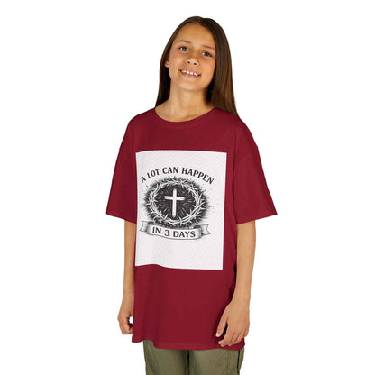 Kids tee with vintage cross design and "A Lot Can Happen in 3 Days" faith message on soft midweight cotton