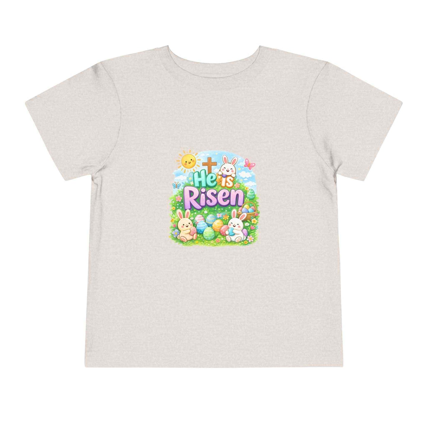 He Is Risen toddler tee with Easter bunny, cross, and pastel eggs design for kids