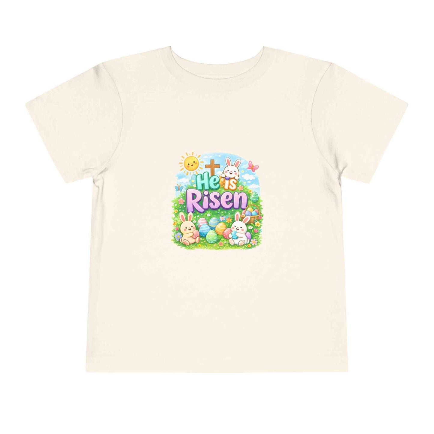 He Is Risen toddler tee with Easter bunny, cross, and pastel eggs design for kids