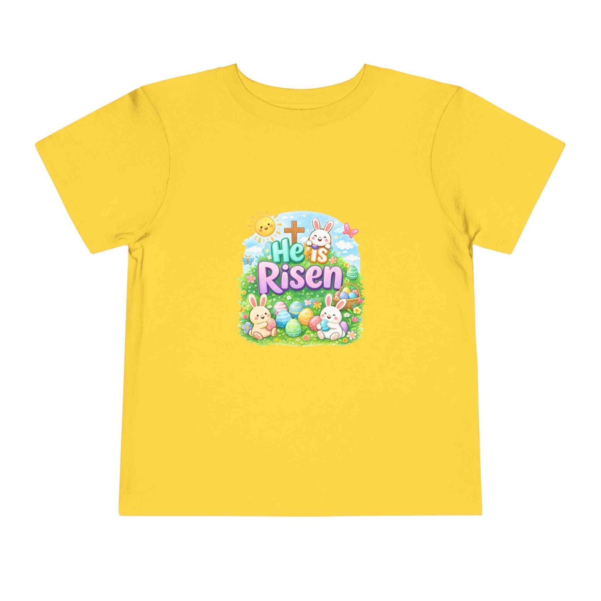 He Is Risen toddler tee with Easter bunny, cross, and pastel eggs design for kids