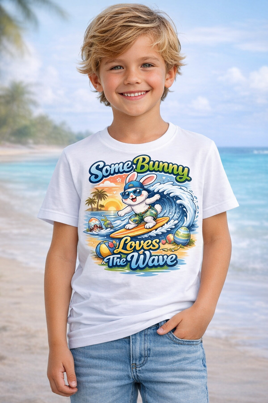 Youth boy’s t-shirt with pastel surfing bunny and Easter eggs saying Some Bunny Loves The Wave