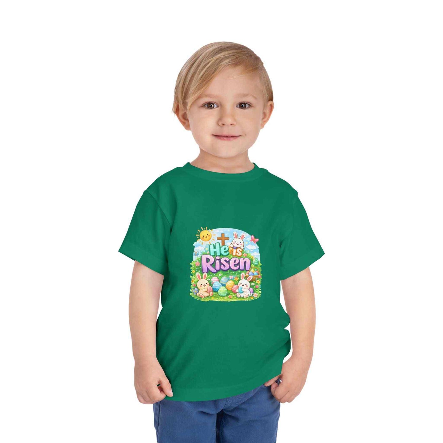 He Is Risen toddler tee with Easter bunny, cross, and pastel eggs design on soft cotton shirt