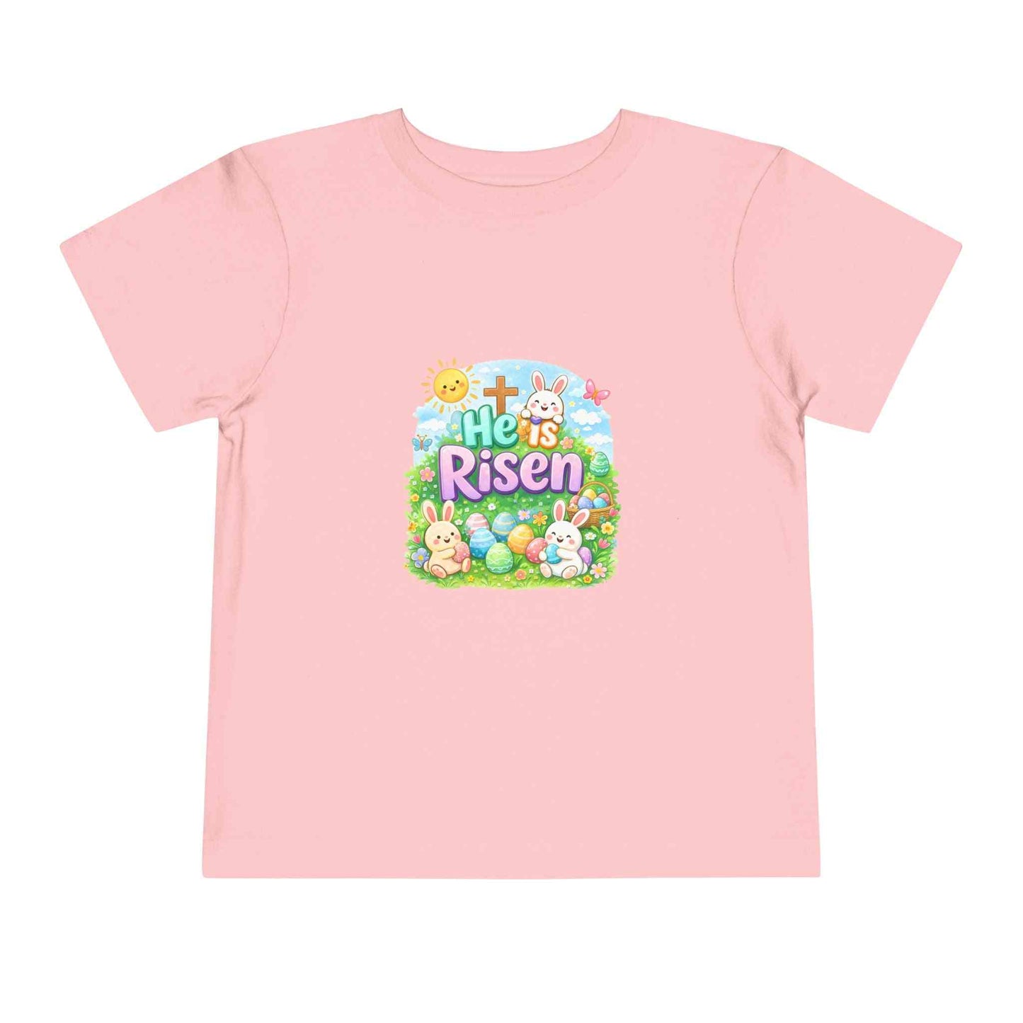 He Is Risen toddler tee with Easter bunny, cross, and eggs in pastel colors on soft cotton shirt