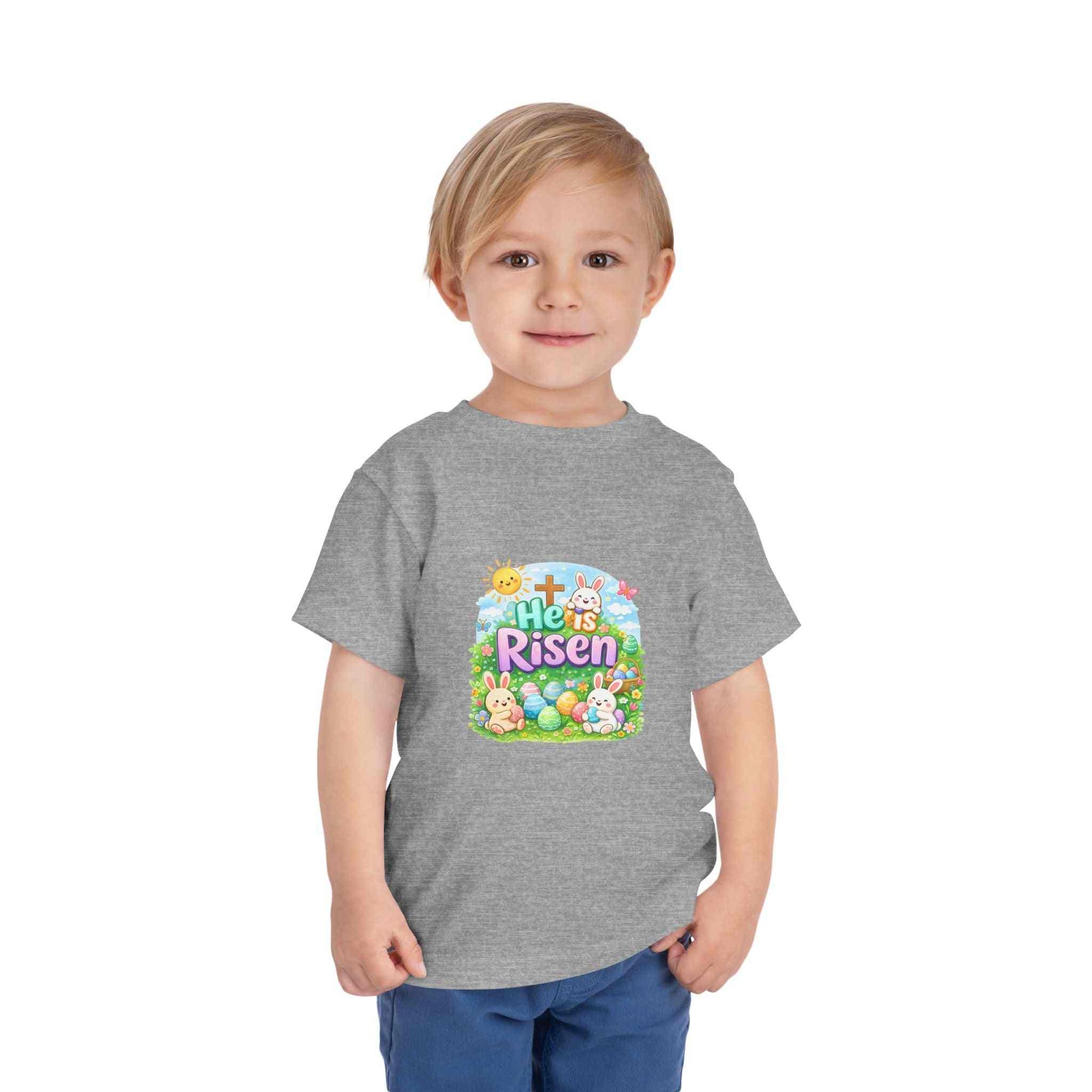 Toddler wearing He Is Risen tee with Easter bunny and cross design in pastel colors