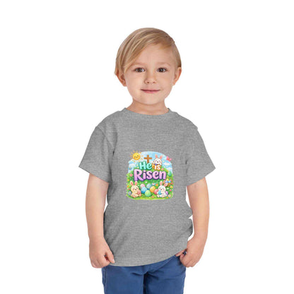 Toddler wearing He Is Risen tee with Easter bunny and cross design in pastel colors