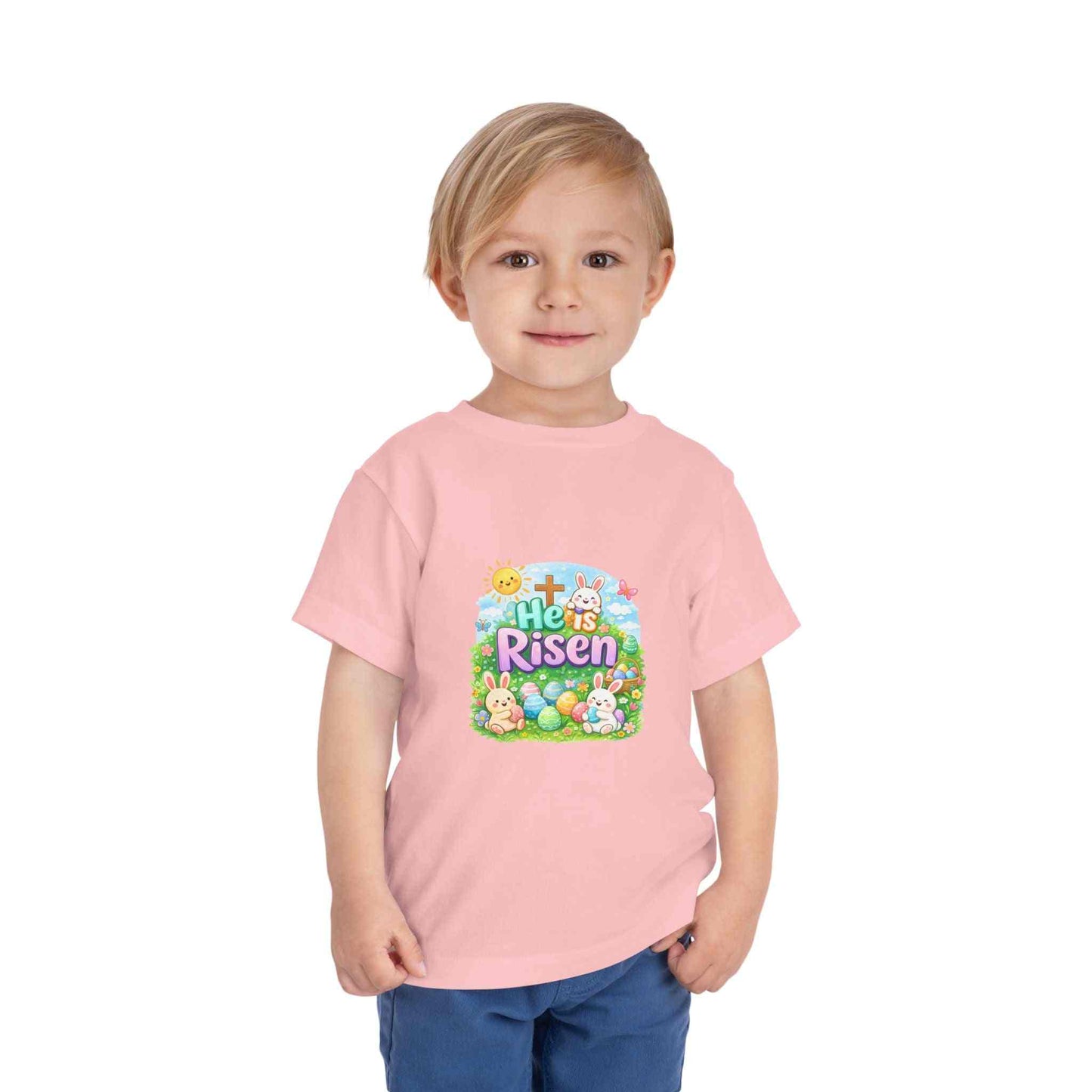 He Is Risen toddler tee with Easter bunny, cross, and pastel eggs design on soft, lightweight fabric