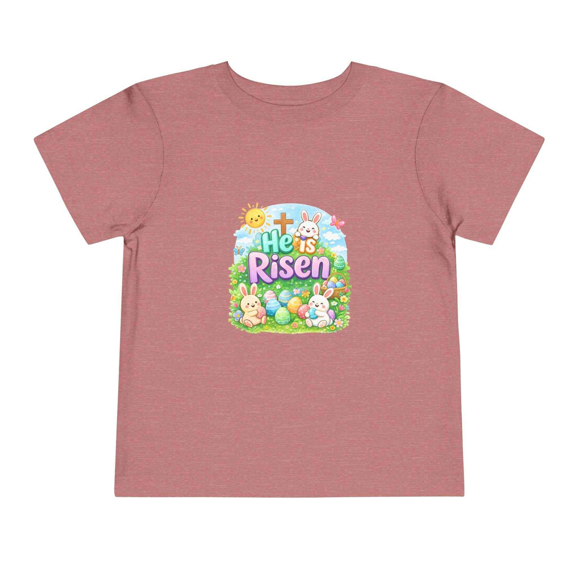 He Is Risen toddler tee with Easter bunny, cross, and pastel eggs design on soft cotton kids shirt