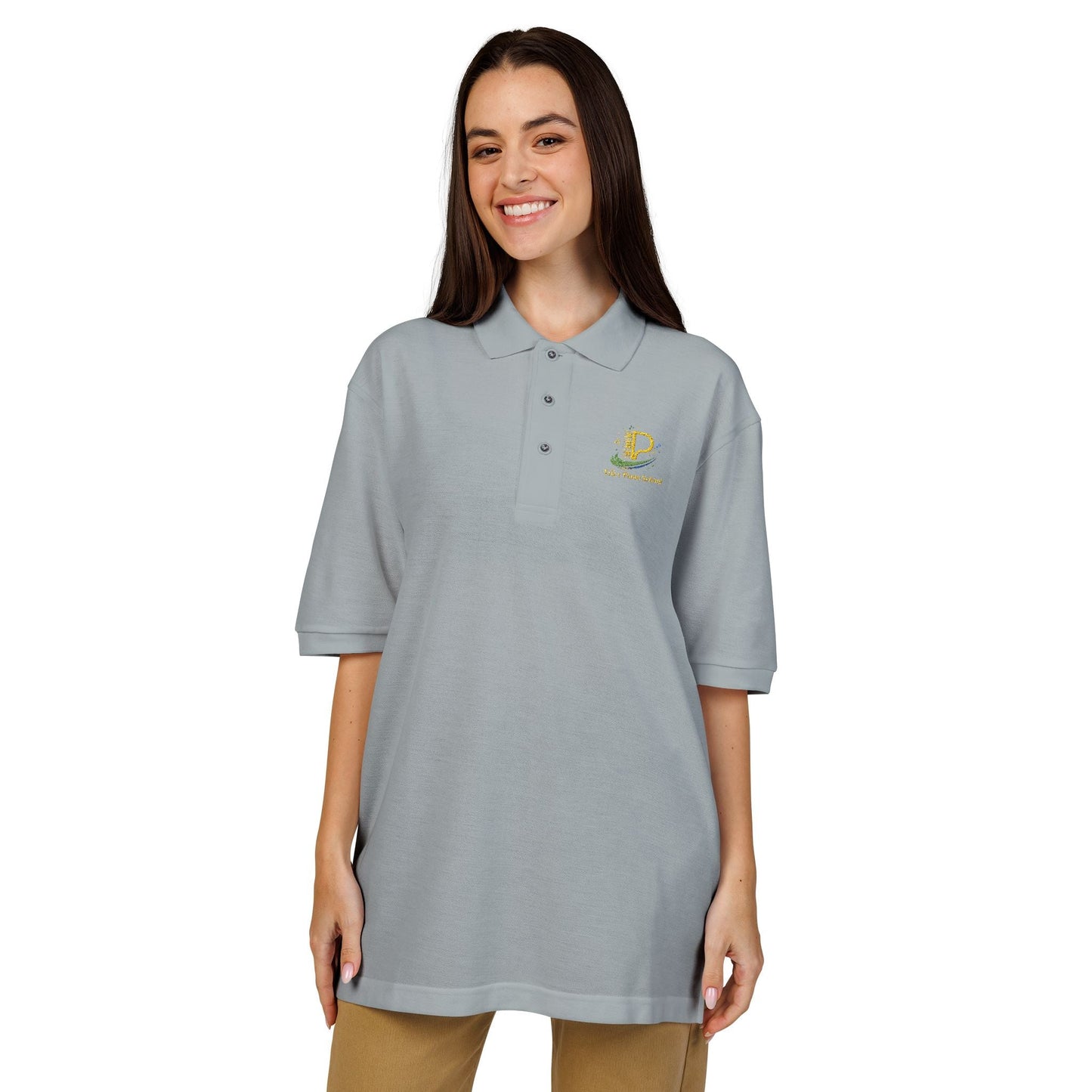 Embroidered crest polo shirt with relaxed fit, flat knit collar, metal buttons, breathable lightweight pique fabric, and subtle chest emblem