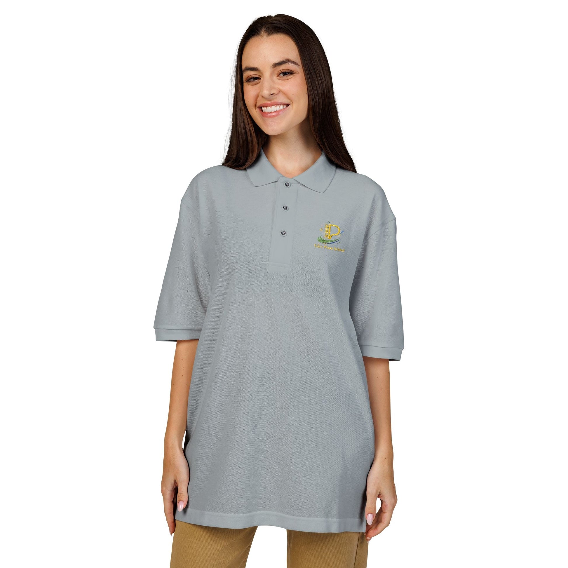Embroidered crest polo shirt with relaxed fit, flat knit collar, metal buttons, breathable lightweight pique fabric, and subtle chest emblem