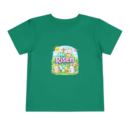 He Is Risen toddler tee with Easter bunny, cross, and eggs design on soft pastel shirt for kids