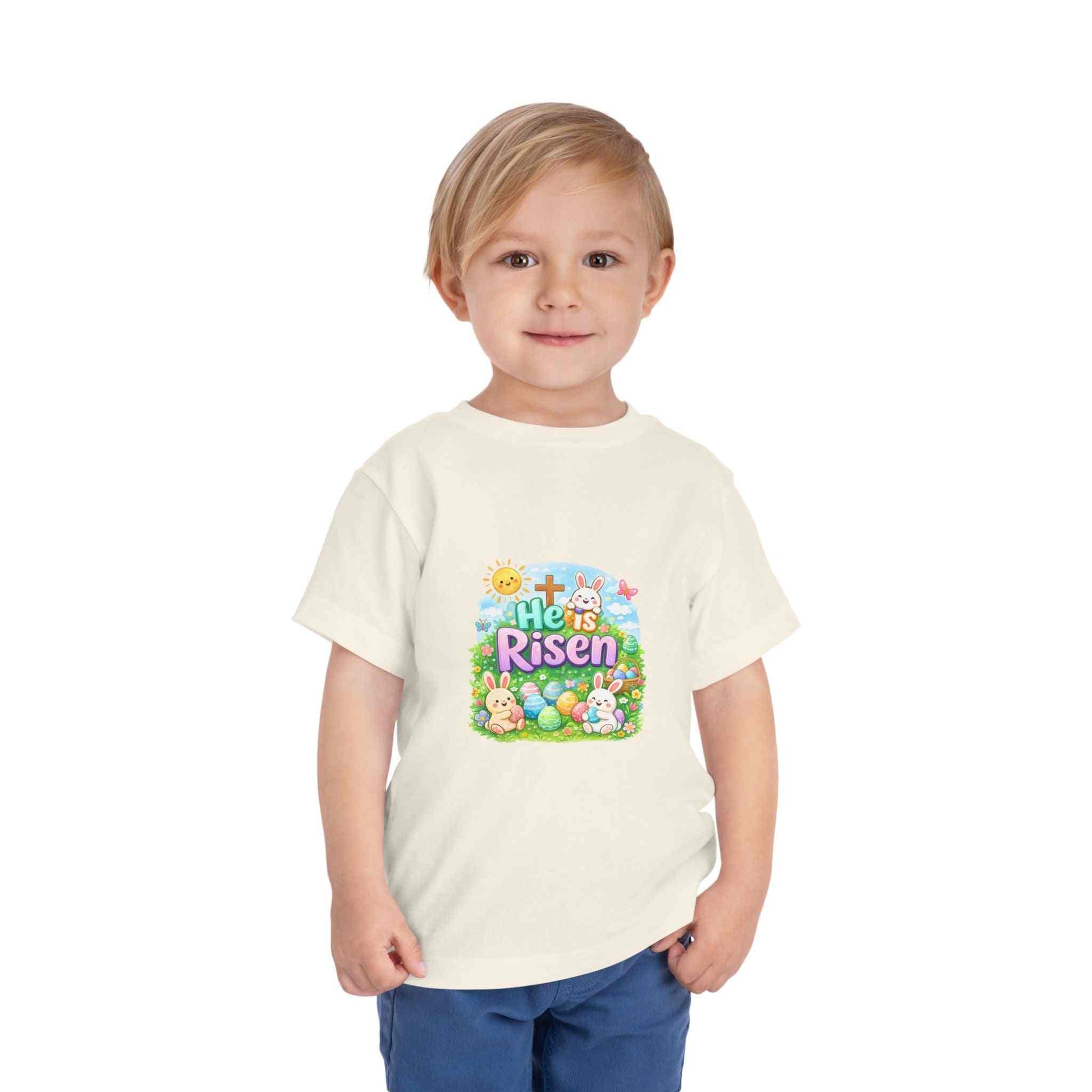 He Is Risen toddler tee with Easter bunny and cross design on soft pastel kids shirt